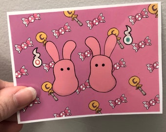 May include: Pink bunny rabbit illustration with candy and lollipop designs on a pink background.