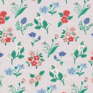 May include: A seamless pattern featuring a variety of flowers in shades of pink, red, blue, and white on a light purple background. The flowers are arranged in a random pattern and include forget-me-nots, lilies of the valley, and other small blossoms.