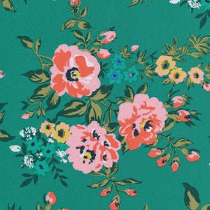 May include: A green fabric with a floral pattern featuring pink, red, and yellow flowers. The flowers are surrounded by green leaves.