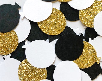 May include: Assortment of black, white, and gold confetti circles. The circles are made of paper and have a variety of textures, including glitter and plain.