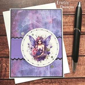 May include: Purple greeting card with a white circle featuring a fairy with purple wings and flowers. The fairy is holding a blue flower. The background is a purple watercolor design.