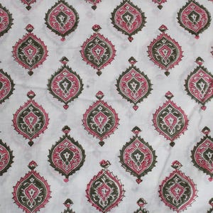 May include: White fabric featuring a repeating pattern of pink, dark green, and grey teardrop shapes. The design is symmetrical and ornate, with each shape containing interior details.