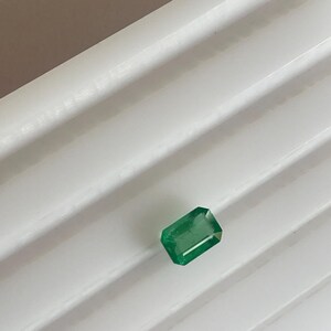 Puede incluir: Una tabla de cortar de madera hecha a mano con un acabado natural. La tabla presenta un borde vivo en un lado y una forma rectangular lisa. Mide aproximadamente 45 cm de largo y 30 cm de ancho.