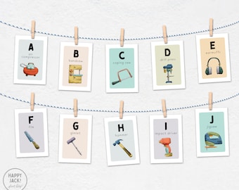 May include: A set of alphabet flashcards featuring tools and equipment. Each card has a letter, a tool, and the name of the tool. The tools include an air compressor, bandsaw, coping saw, drill press, file, gimlet, hammer, impact driver, jigsaw, and earmuffs.