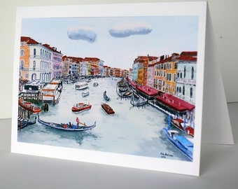 May include: A watercolor painting of a canal in Venice, Italy. The canal is lined with colorful buildings and there are several boats in the water. The sky is blue with white clouds.