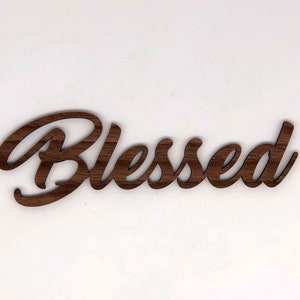May include: A wooden sign with the word "Blessed" written in a cursive font.