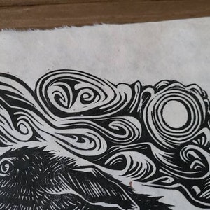 May include: Black and white linocut print of a rabbit with swirling patterns around it.