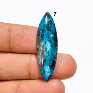 Pu&ograve; includere: Una pietra preziosa cabochon blu e grigia con una forma ovale appuntita. La pietra preziosa &egrave; lunga circa 6,5 cm e larga 2,5 cm. La pietra preziosa presenta un motivo unico di vortici blu e grigi. La pietra preziosa &egrave; etichettata con il numero "7".