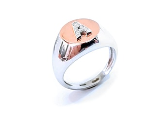 May include: A silver signet ring with a rose gold oval top featuring the letter "A" set with small diamonds.