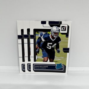 May include: A white and black football trading card featuring a football player wearing a blue and white uniform with the number 54. The card has the text "Rated Rookie" and "Sam Williams, Dallas Cowboys".