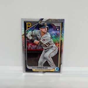 May include: A baseball card featuring Nick Gonzales of the Pittsburgh Pirates in a batting stance. The card has a chrome finish with a geometric pattern and the team's logo. The player is wearing a gray and black uniform with the number 39.