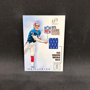 May include: A Fleer Legacy NFL trading card featuring Rob Johnson of the Buffalo Bills. The card displays a photo of the player in a blue and white uniform, an NFL Game Issue logo, a blue jersey swatch, and the text 1st Quarter.