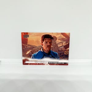 May include: A trading card featuring Benedict Cumberbatch as Doctor Strange (Earth-838). The card has a photo of Cumberbatch in a blue costume. The card has the Upper Deck logo.