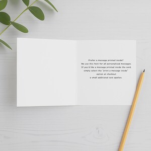 May include: An open white greeting card with black text that reads: Prefer a message printed inside? We use this font for all personalised messages. If you'd like a message printed inside the card, simply select the print a message inside option at checkout, a small additional cost applies.