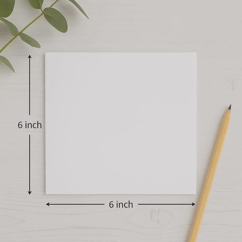 May include: A square white card with smooth edges. Dimension lines indicate a height of 6 inches and a width of 6 inches. A yellow wooden pencil with a sharpened tip is positioned diagonally to the right of the card, and a green leaf is visible.