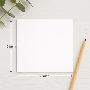 Flat lay of a blank white 6x6 inch square greeting card on a white desk with a pencil and kraft envelope – ideal mockup for Etsy birthday card listings or personalised stationery designs.