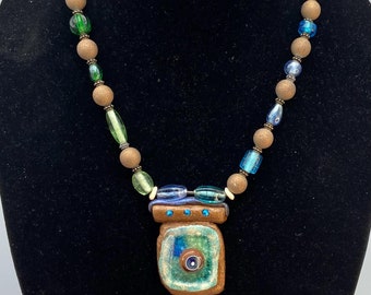 Ocean Blue & Green Melted Glass on A Raku Pendant on a Sparkly Glass Beaded Necklace