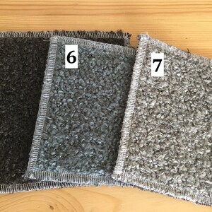 May include: Three textured fabric swatches in shades of gray, with white stitching around the edges. The swatches are labeled with the numbers 5, 6, and 7. The fabric has a looped, curly texture.