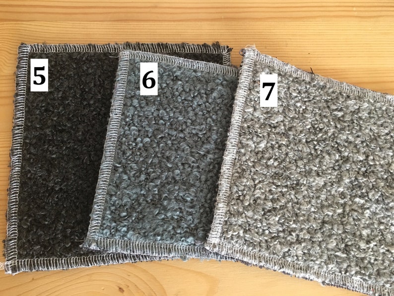 May include: Three textured fabric swatches in shades of gray, with white stitching around the edges. The swatches are labeled with the numbers 5, 6, and 7. The fabric has a looped, curly texture.