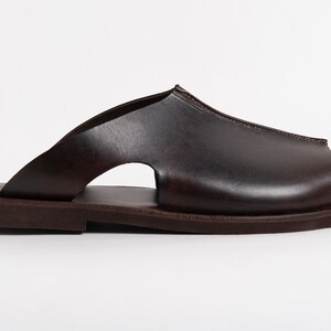 May include: A set of three ceramic mugs with a speckled, matte finish. The mugs are in shades of cream, light gray, and dark gray. Each mug has a simple, minimalist design, perfect for coffee or tea.