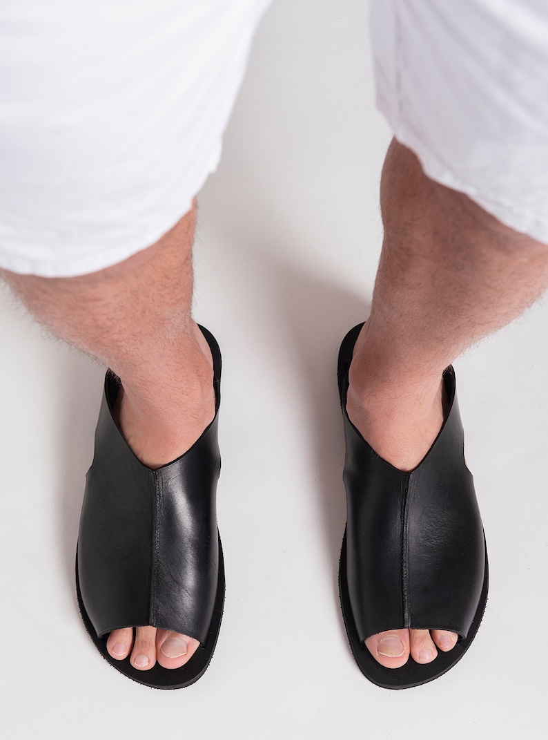 May include: A set of three ceramic mugs with a speckled, matte finish. The mugs are in shades of cream, light gray, and dark gray. Each mug has a simple, minimalist design and a rounded handle.