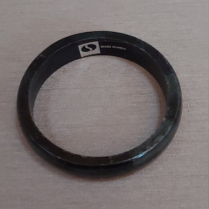 May include: Black metal ring with a small logo and the text "MADE IN INDIA".