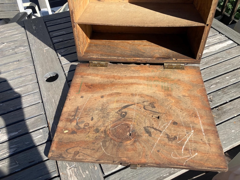 May include: A wooden box with a hinged lid. The box is open and the inside is empty. The box has a shelf inside and is made of unfinished wood.