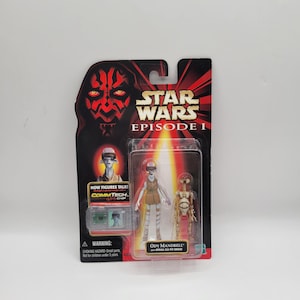 May include: Star Wars Episode I action figure set featuring Ody Mandrell and a 0906A 222 Pit Droid. The packaging includes the text "Now Figures Talk!" and "CommTech Chip". The card art features Darth Maul.