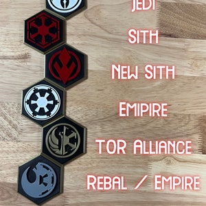 May include: Six hexagonal game pieces with different Star Wars faction symbols. The symbols are: Jedi, Sith, New Sith, Empire, Tor Alliance, and Rebel/Empire. The pieces are arranged vertically in a column.
