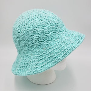May include: A light blue crocheted sun hat with a wide brim.