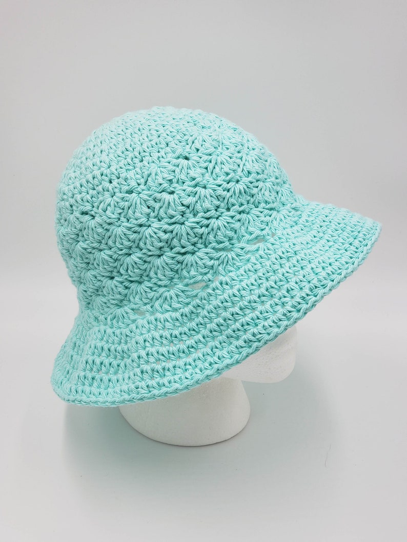 May include: A light blue crocheted sun hat with a wide brim.