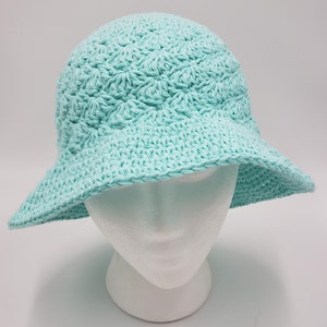 May include: A light blue crocheted sun hat with a wide brim.