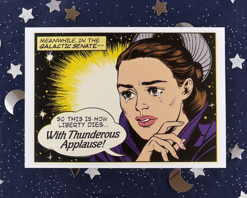 May include: A comic book style illustration of a woman with a tear rolling down her cheek. The text in the image reads "MEANWHILE, IN THE GALACTIC SENATE-- SO THIS IS HOW LIBERTY DIES... With Thunderous Applause!"