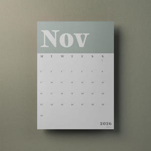 May include: A wall calendar page for November 2026 featuring a sage green header with the text Nov in white serif font. The grid below displays the days of the week from Monday to Sunday with dates numbered 1 through 30 in black text.