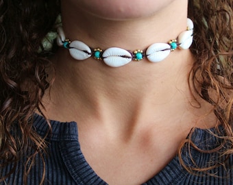 Cowrie Shell Choker on brown cord with turquoise coloured bead and brass beading