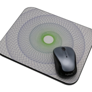May include: A gray and black wireless mouse with the Logitech logo on the bottom, resting on a white mouse pad with a blue and green geometric pattern.