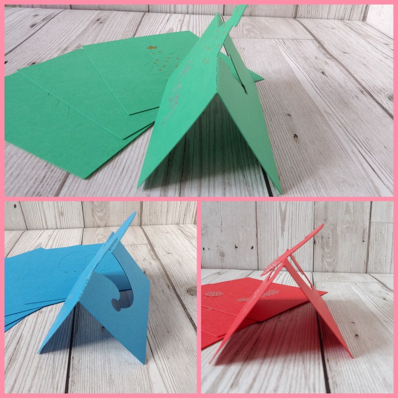 A collage of photos showing each place card from a side on view. At the top is the green place card with a Christmas tree cut out of it, bottom left is the blue place card with an elf hat cut out and bottom right the red place card with a Santa hat.