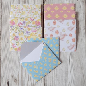 May include: A set of colourful envelopes with different Easter-themed patterns. The envelopes feature chicks, eggs, and floral designs. The envelopes are perfect for sending Easter greetings.