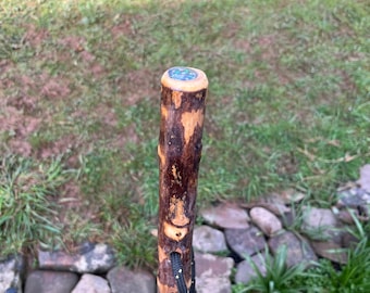 A 45.5 Chinese birch Hiking Stick: rustic Shaft with a natural patina, a smooth thumb rest with inset compass and a Paracord wrist strap