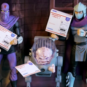 May include: Action figures of characters from the Teenage Mutant Ninja Turtles franchise. The figures are holding white boxes with "PRIORITY MAIL" printed on them. The figures are in a room with a brick wall.