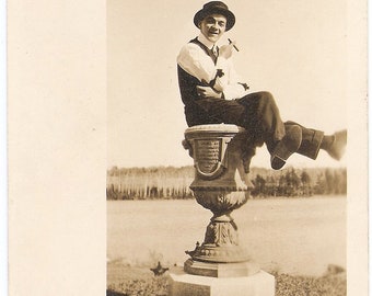 Vintage c. 1920s Real Photo Postcard of a Cigar-Smoking Guy in a Derby Hat Perched atop a Memorial about the Rebellian of 1066