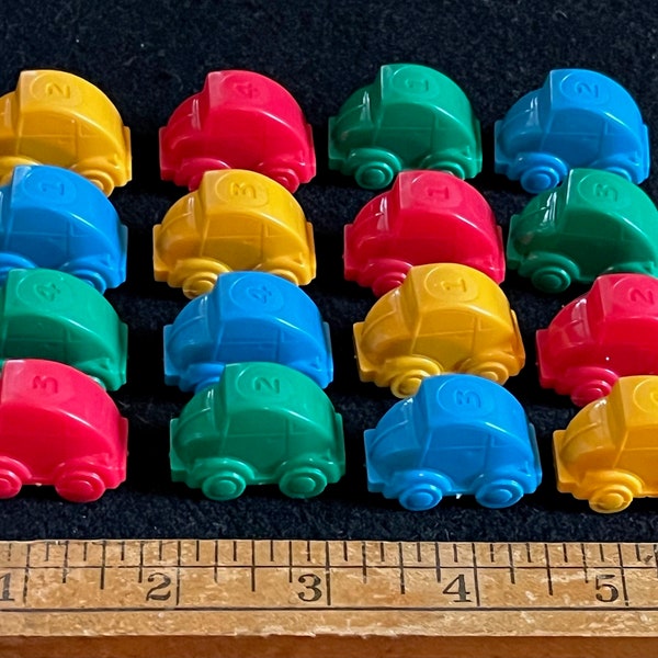 16 Automobile Playing Pieces from a Board Game -- 4, Blue, 4 Yellow, 4 Red, 4 Green -- They Look a Little like Volkswagens