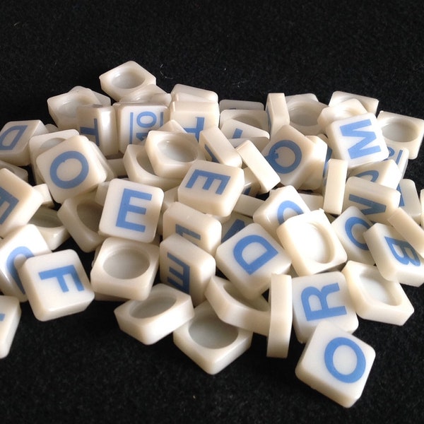 95 Blue and White Plastic Tiles from a Word Forming Game