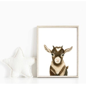 May include: A watercolor painting of a brown and white goat with a white patch on its forehead. The goat is looking directly at the viewer with its mouth slightly open. The background is white.