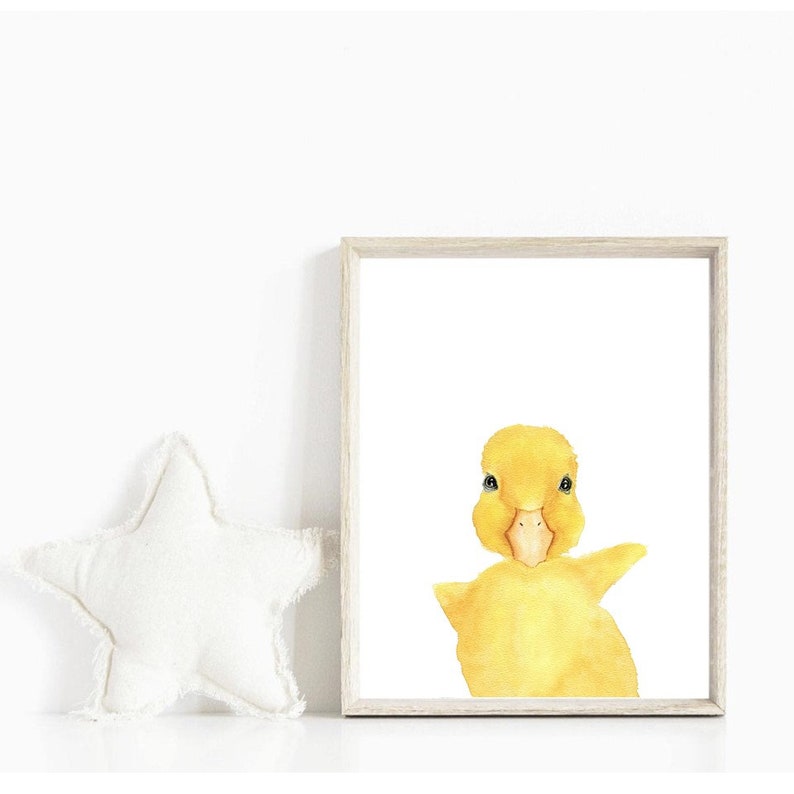 May include: A watercolor painting of a yellow duckling with a white background. The duckling is looking directly at the viewer with its head tilted slightly to the side.
