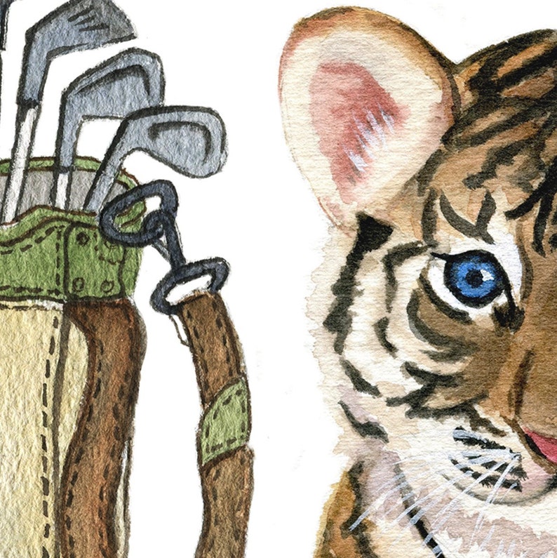 May include: A watercolor painting of a golf bag with clubs and a tiger cub peeking out from the right side of the image. The tiger cub has blue eyes and brown and orange stripes.