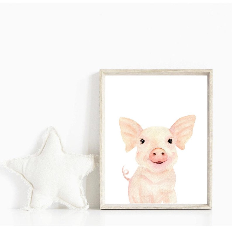 May include: A watercolor painting of a pink pig with large ears and a happy expression. The pig is looking directly at the viewer. The painting is framed in a light wood frame.