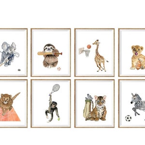 May include: Set of eight watercolor illustrations featuring various animals playing sports. The animals include a sloth playing baseball, a giraffe playing basketball, a lion playing football, a cheetah playing tennis, a monkey playing tennis, a tiger playing golf, a zebra playing soccer, and an elephant playing hockey.
