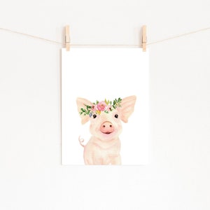 May include: A watercolour illustration of a pink pig wearing a flower crown. The pig is looking at the viewer with a happy expression. The background is white.