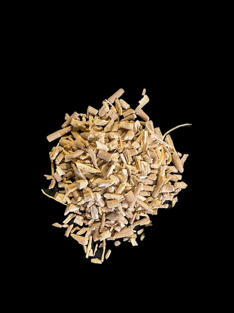 May include: A close-up of a pile of dried, light brown, herbs or roots. The herbs are broken into small pieces and have a rough texture.